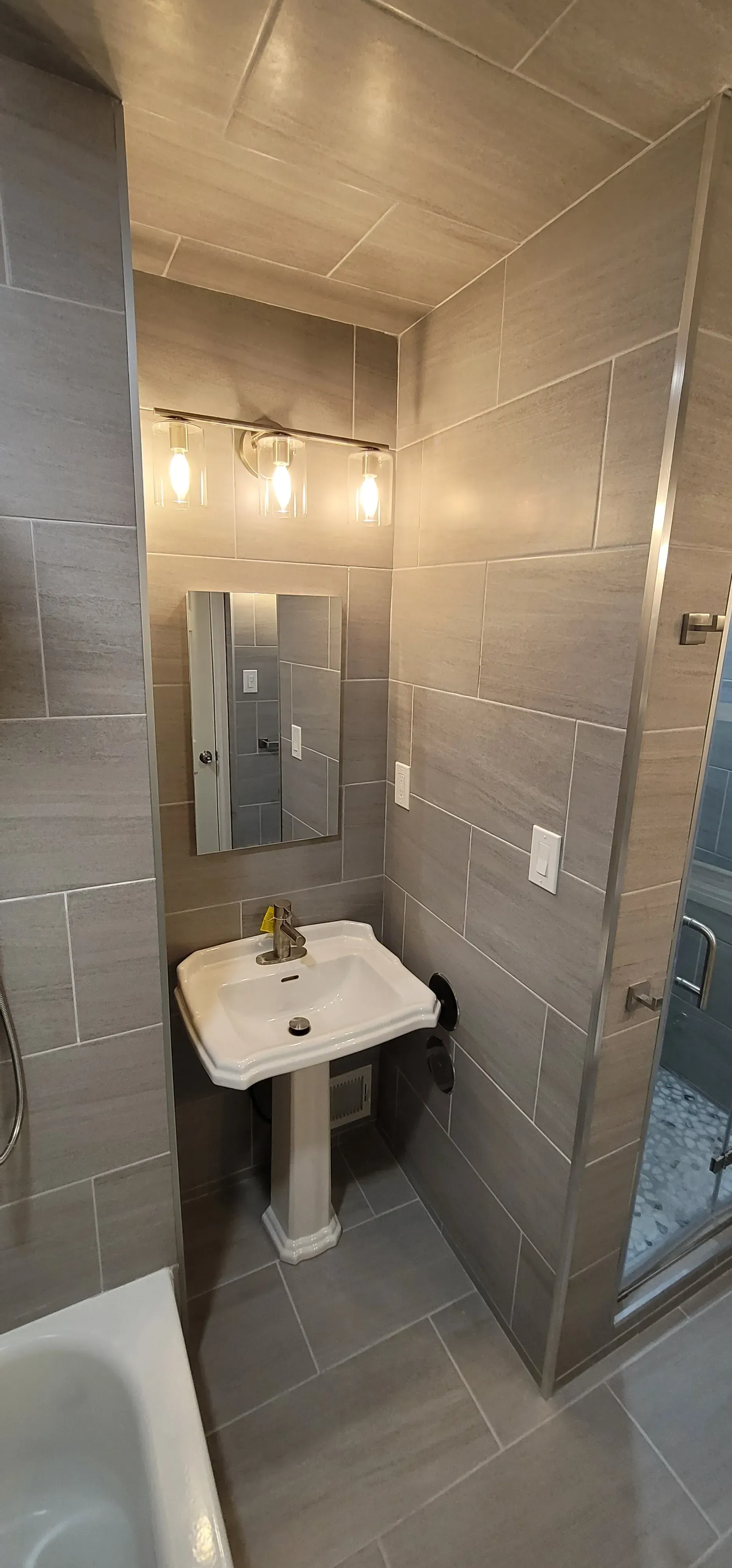 Bathroom with gray tile walls and floor