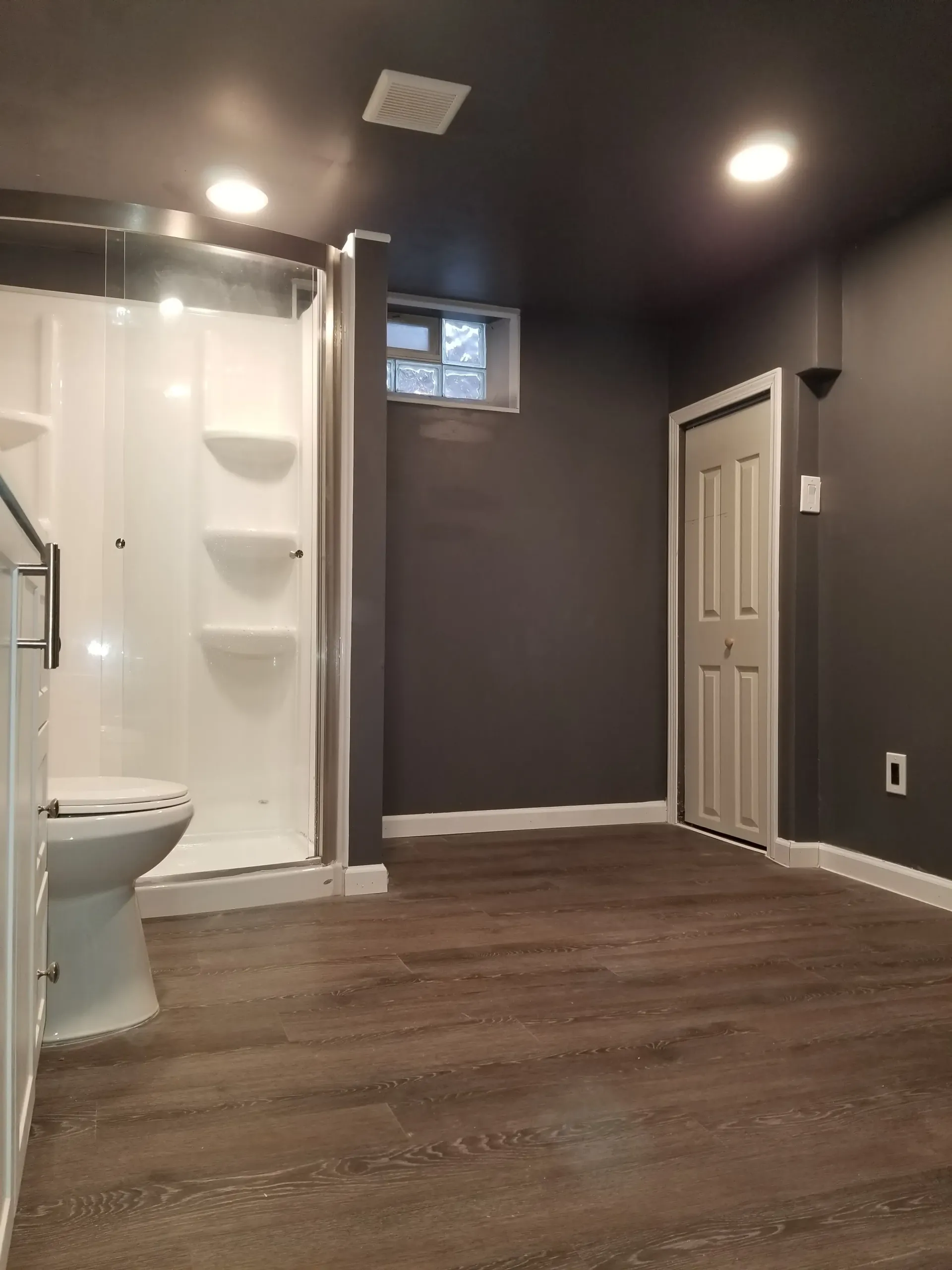 Basement bathroom with a white shower