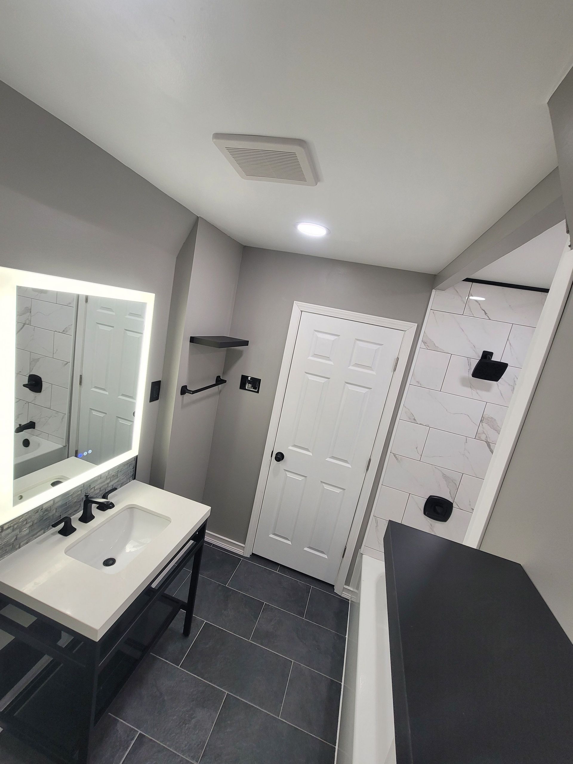 A modern bathroom with a black accents