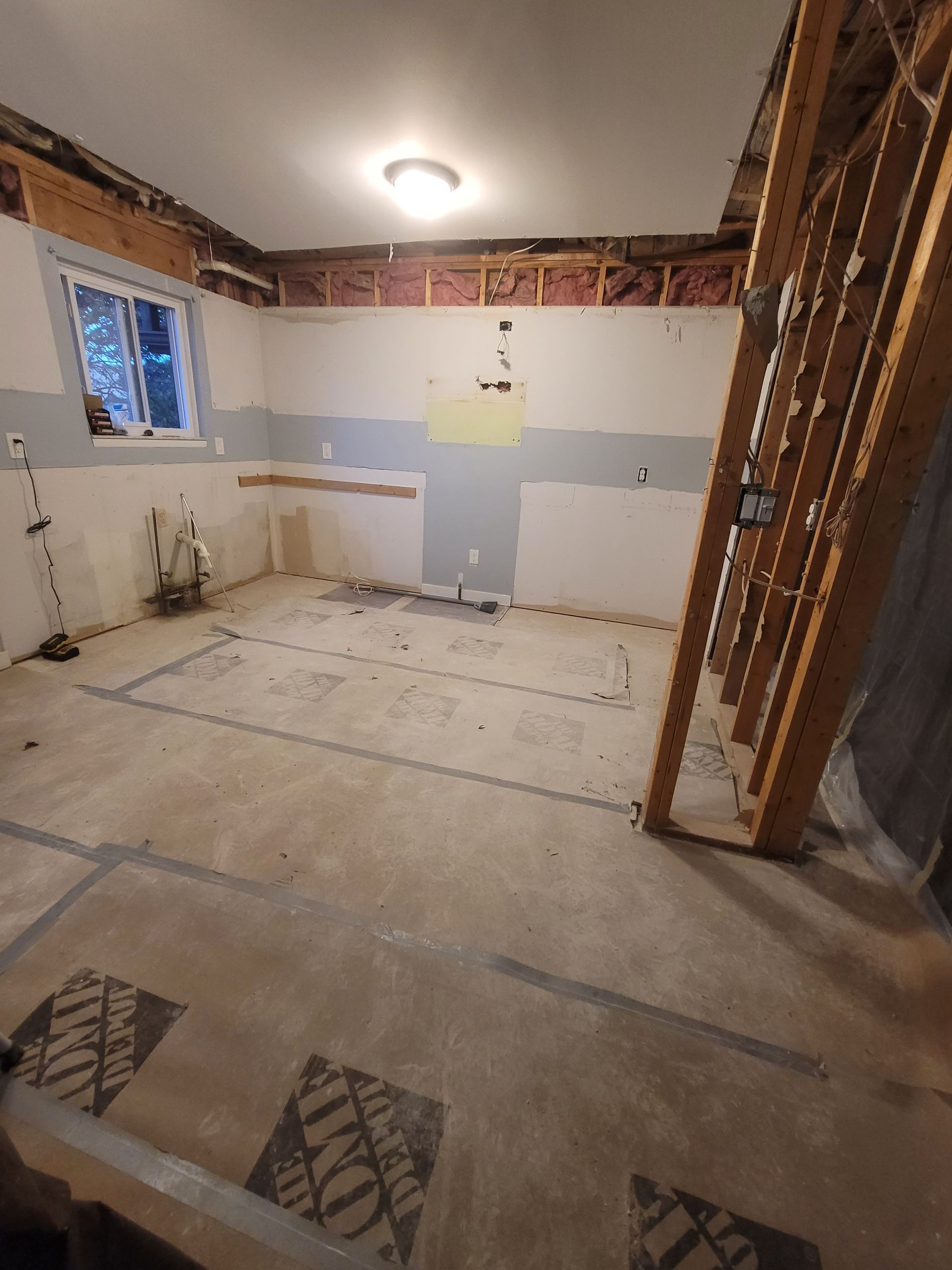 An empty room with a home depot logo on the floor.