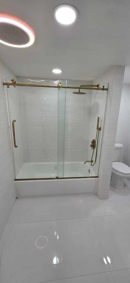 A modern bathroom with a white tiled shower