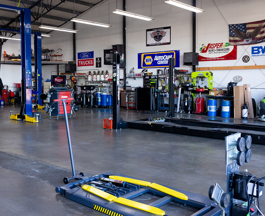 Auto repair shop interior with lifts, tools, and equipment. PJM Auto LLC