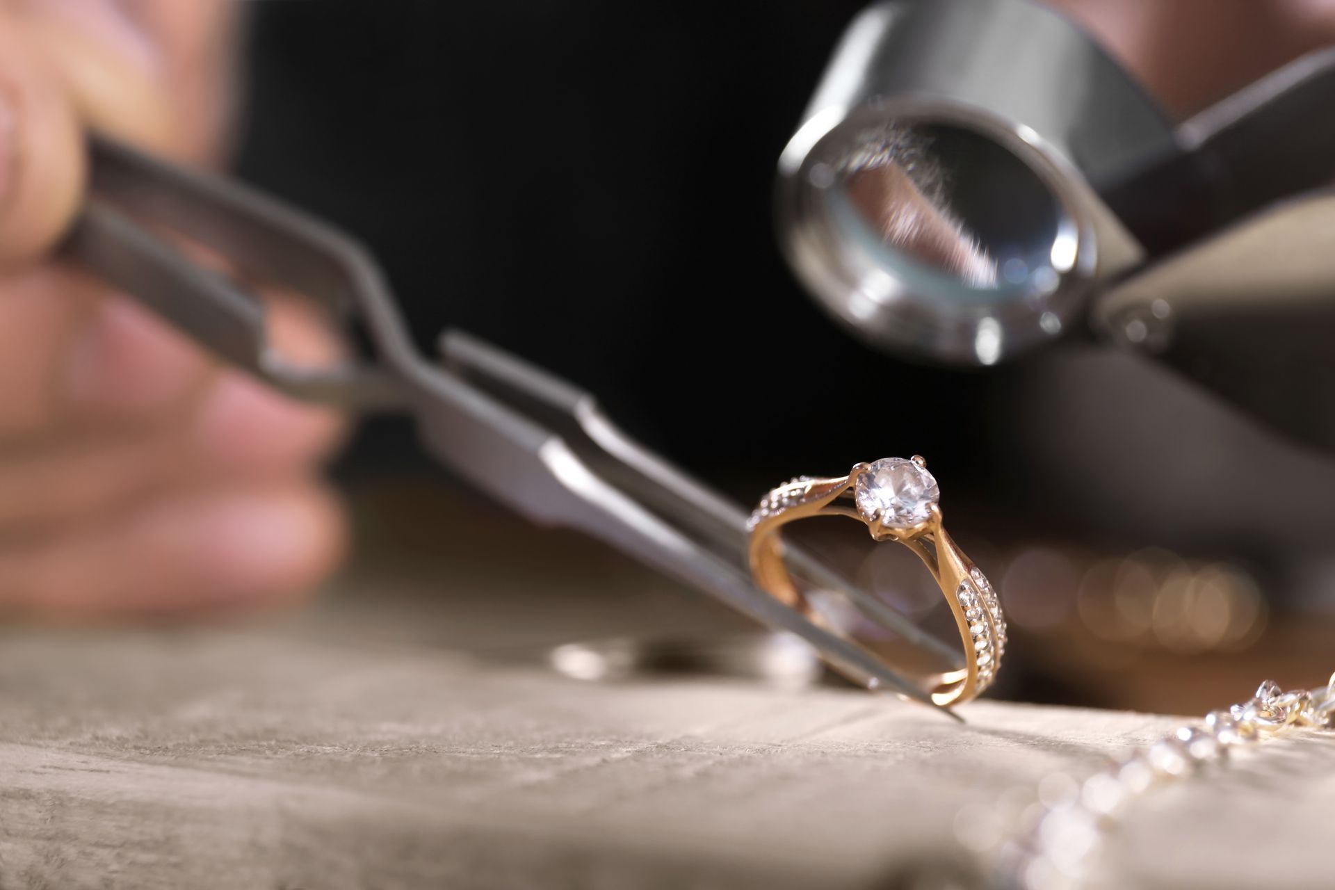 A man is inspecting a diamond ring. A man is inspecting a diamond ring.