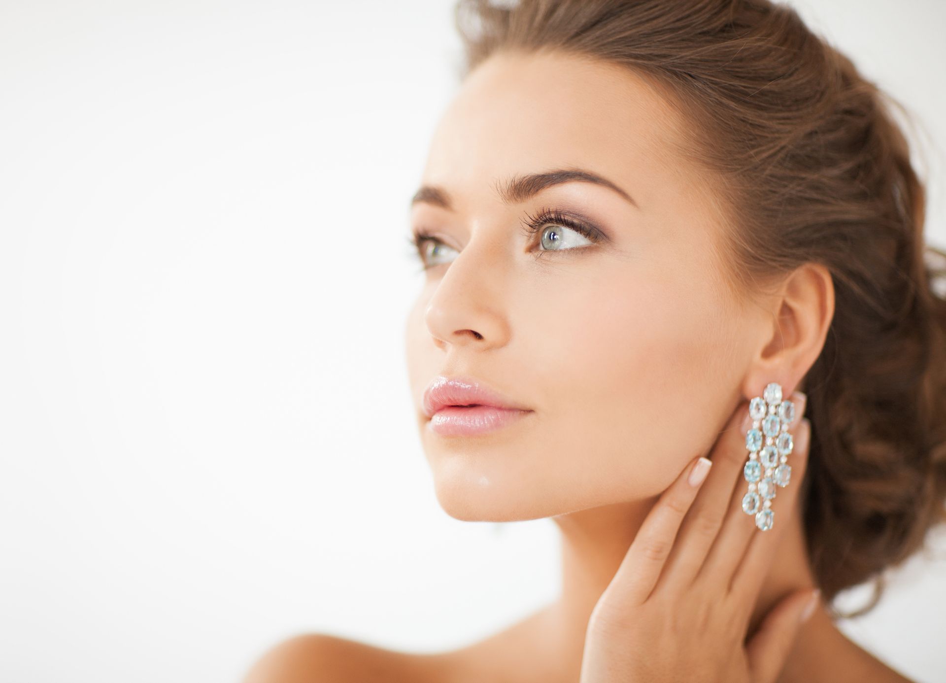 A person with her hand on her ear | Diamond Jewelry in St. Petersburg FL A person with her hand on her ear | Diamond Jewelry in St. Petersburg FL