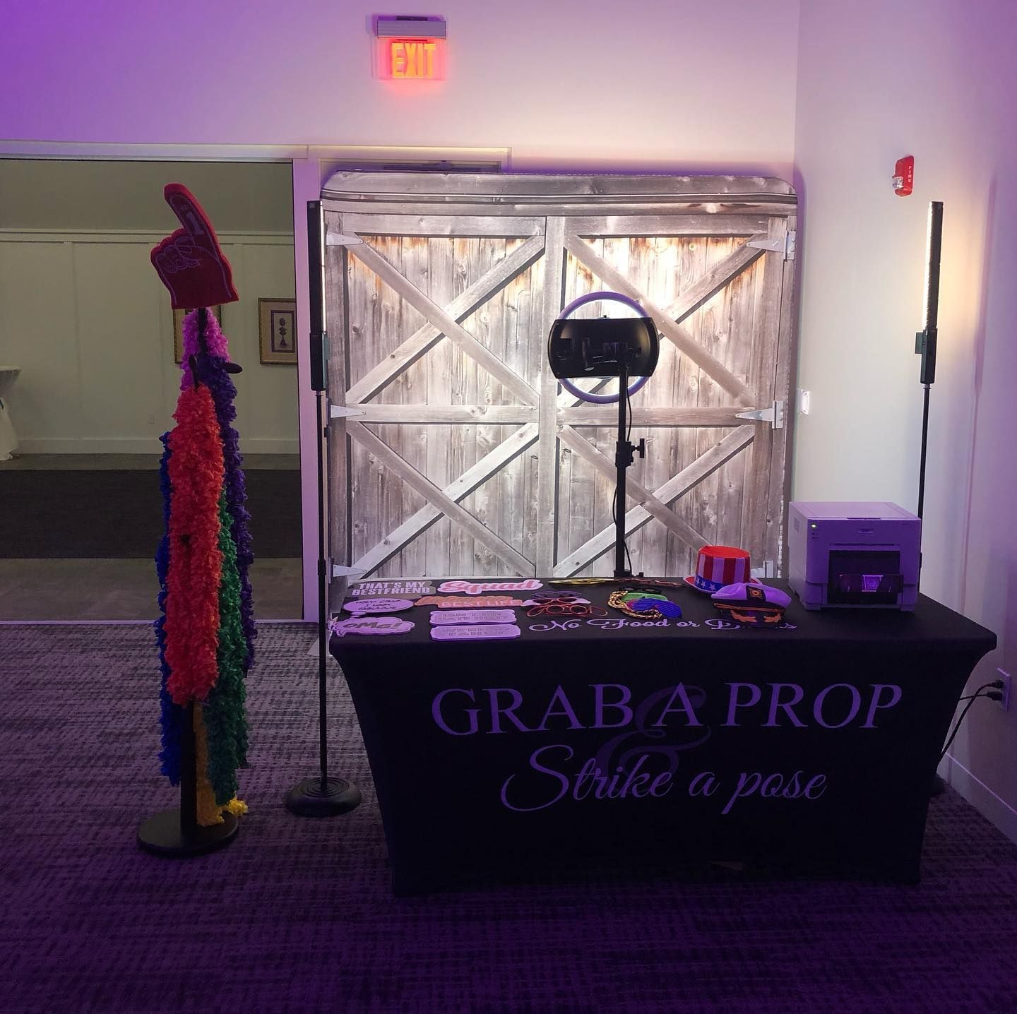 Photo booth setup with props and backdrop; 