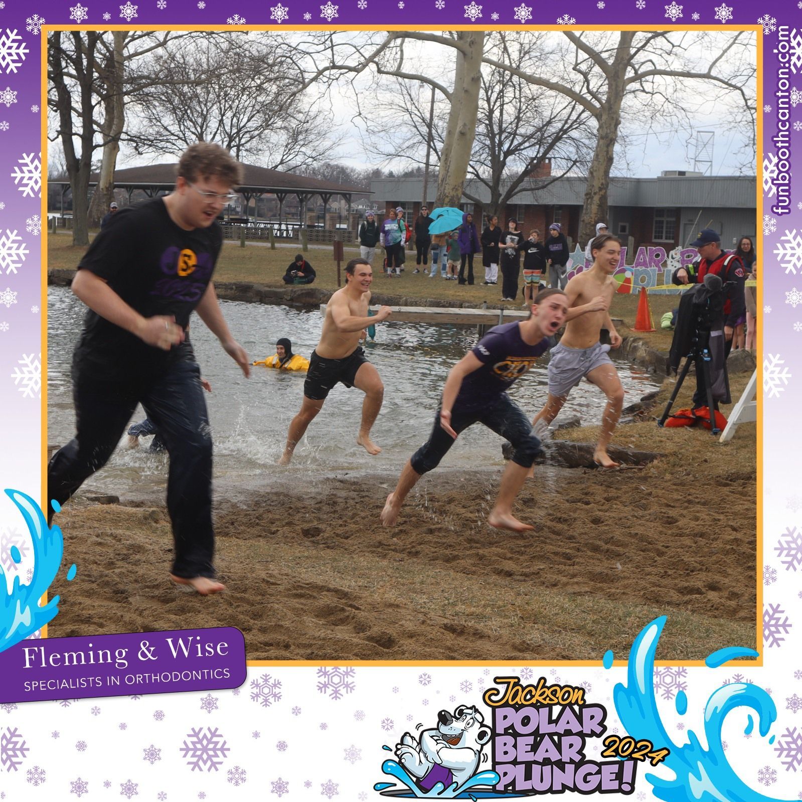 People running out of water after a polar plunge at a lake.