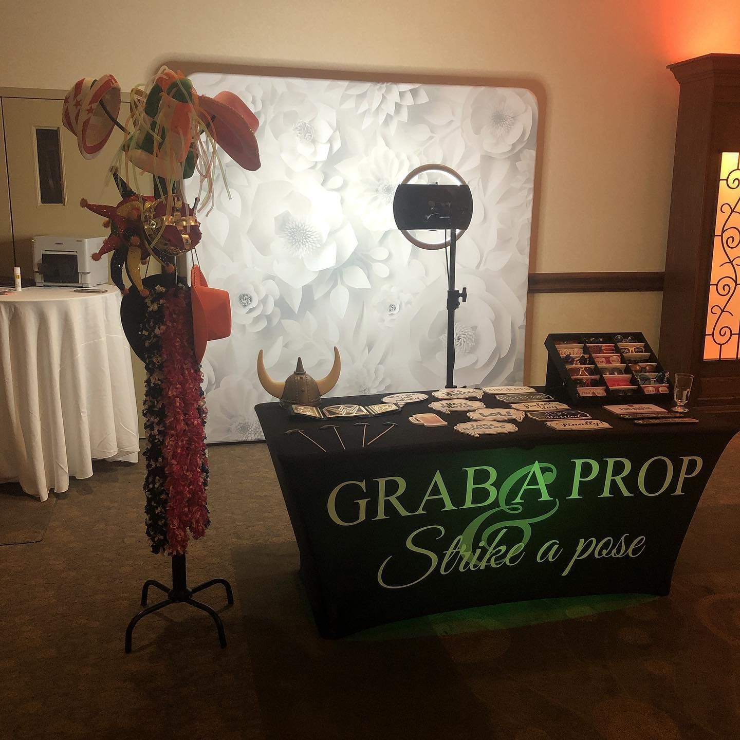 Photo booth setup with props. Backdrop, lighting, and 