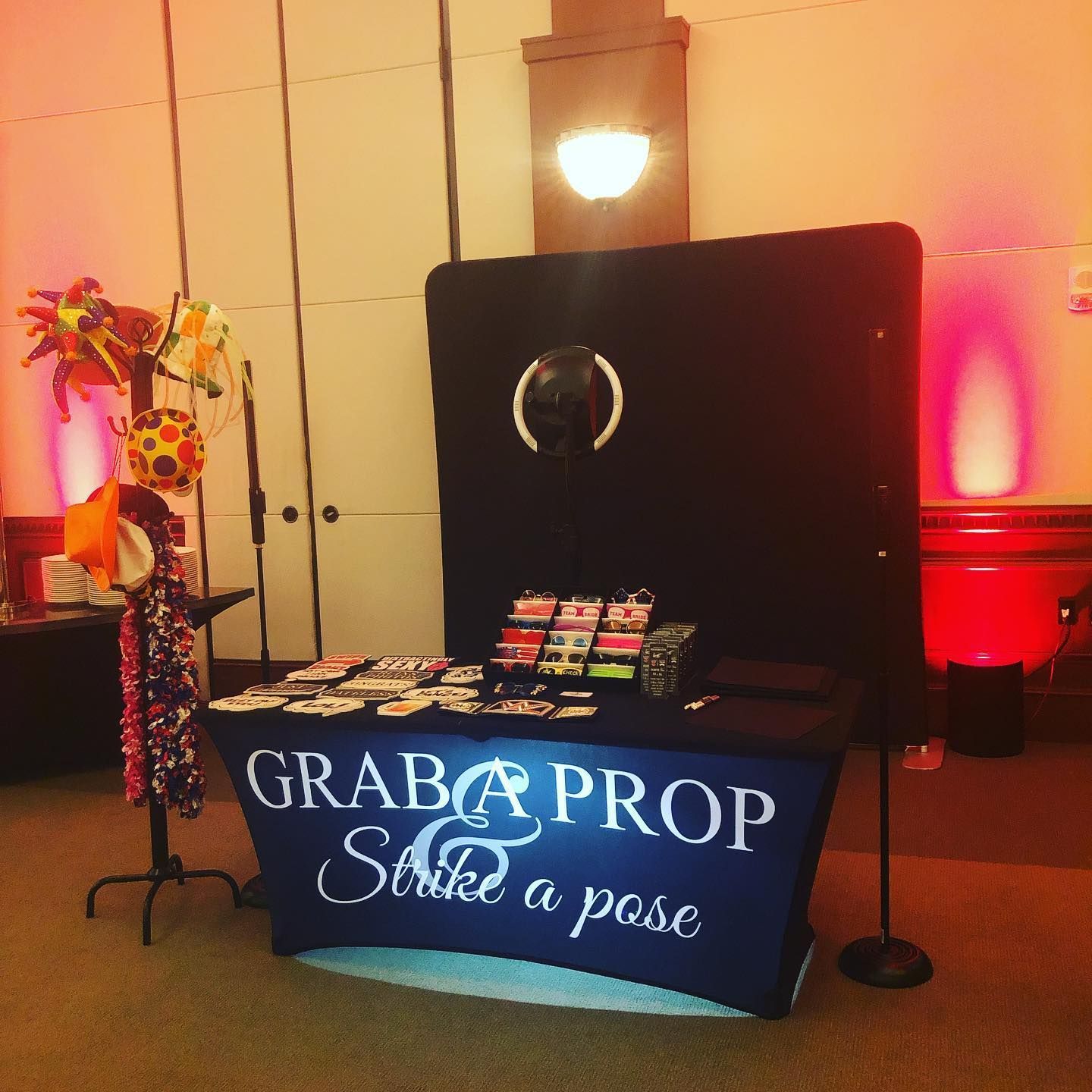 Photo booth setup with props and table, featuring 