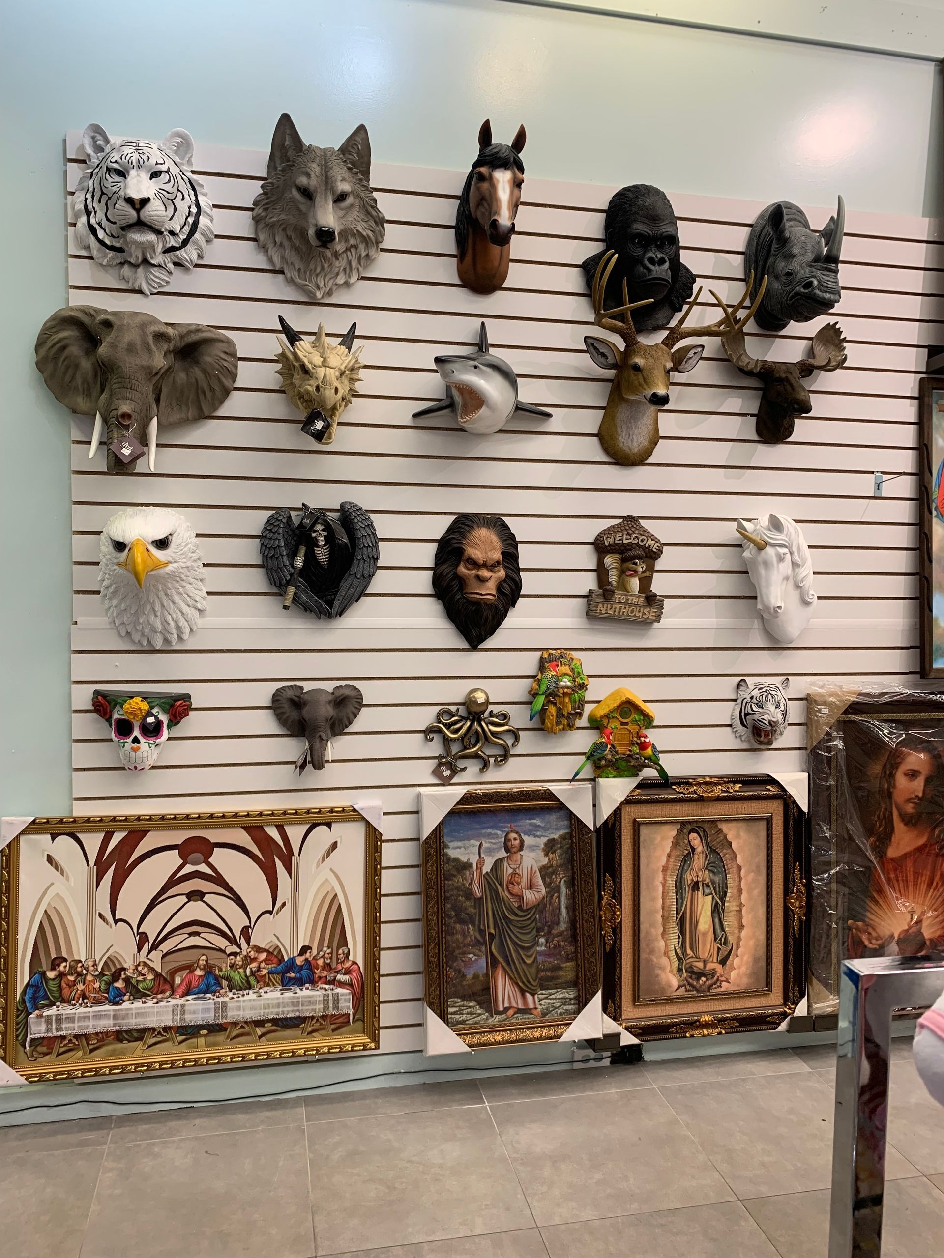 A wall with a lot of animals ' heads on it