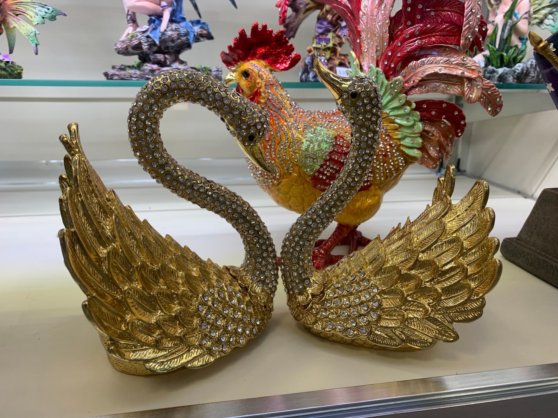 Two gold swans are sitting next to each other on a table
