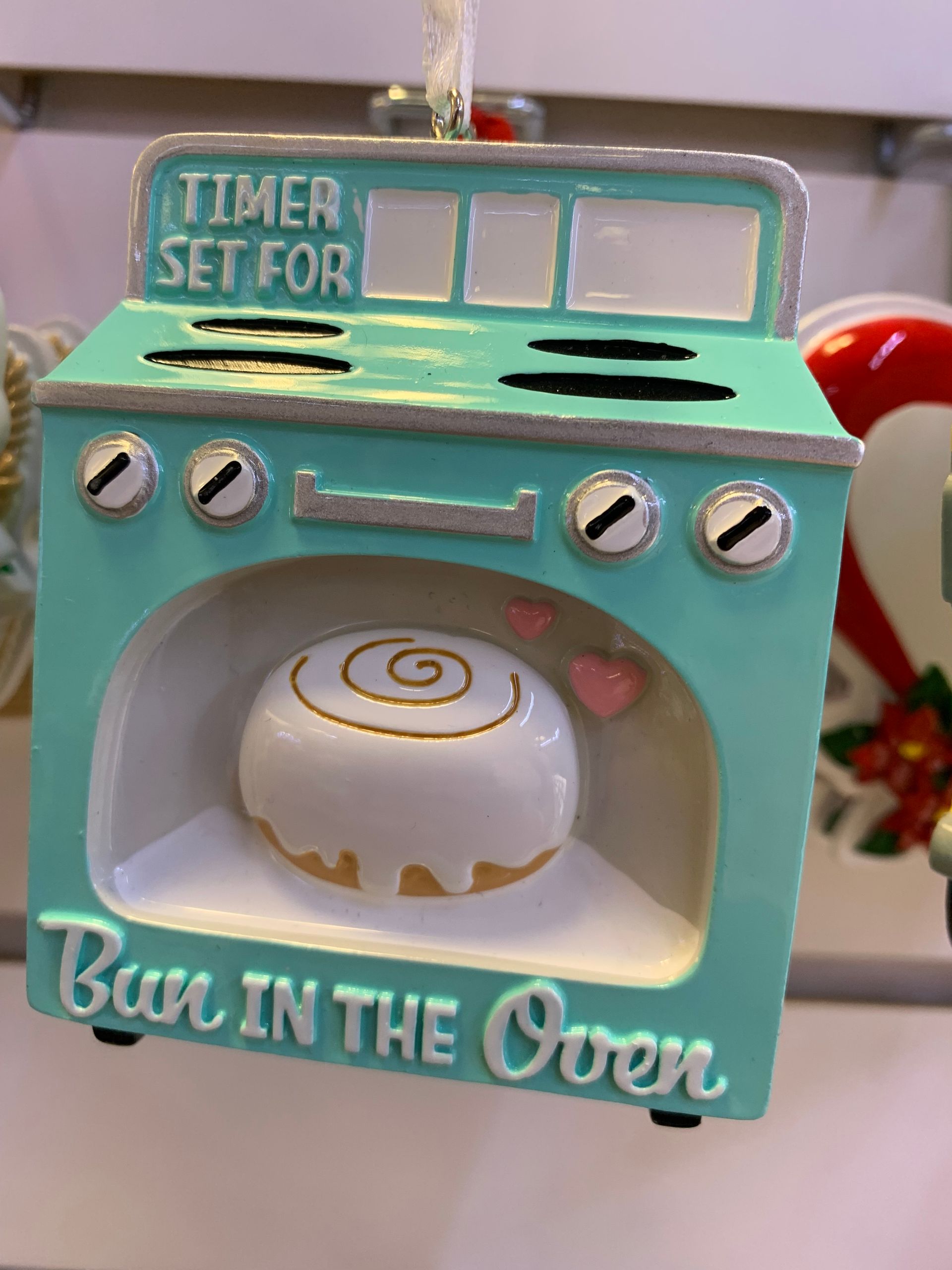 A christmas ornament with a timer set for bake in the oven