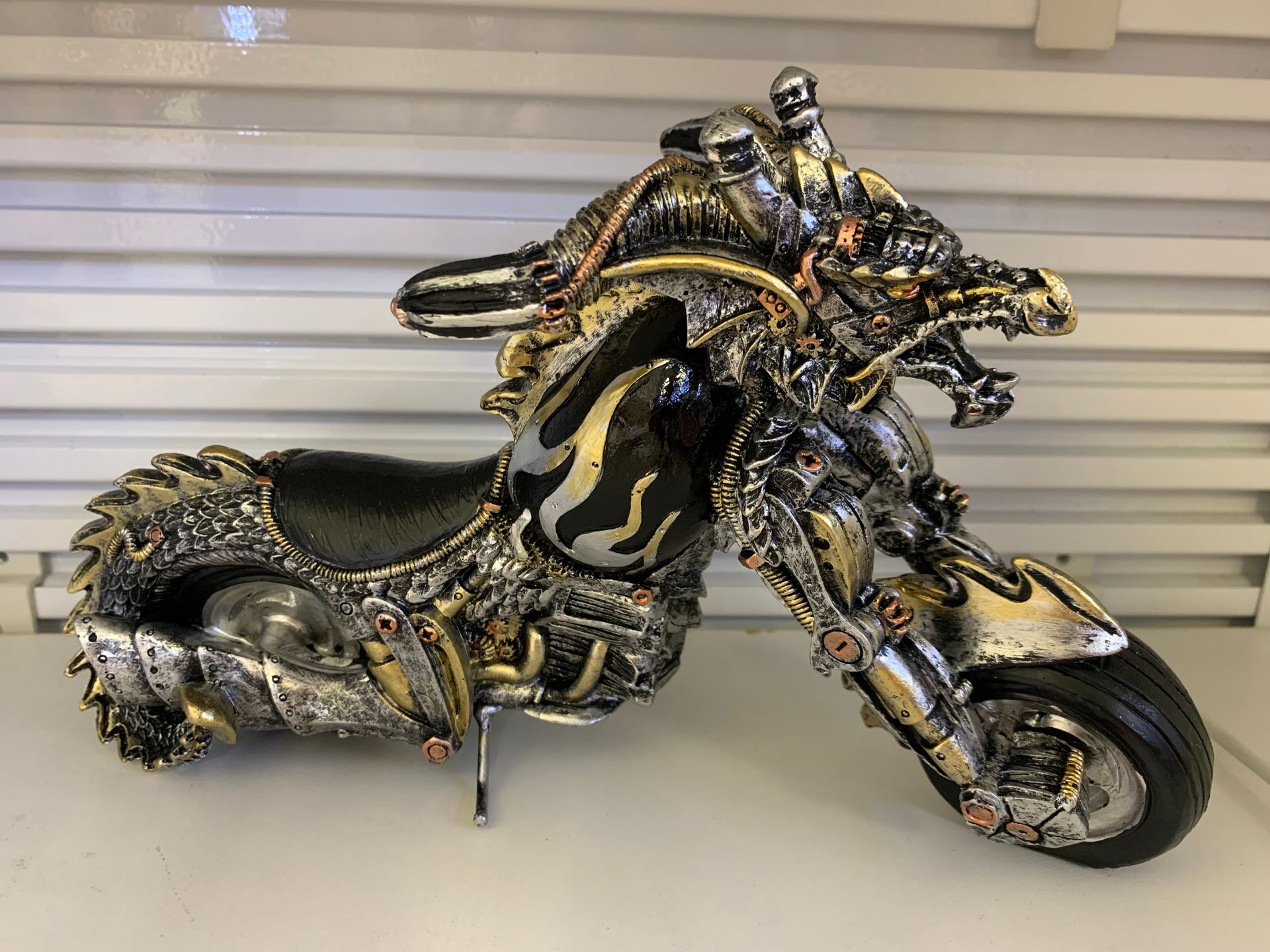 A statue of a motorcycle with a dragon head on it