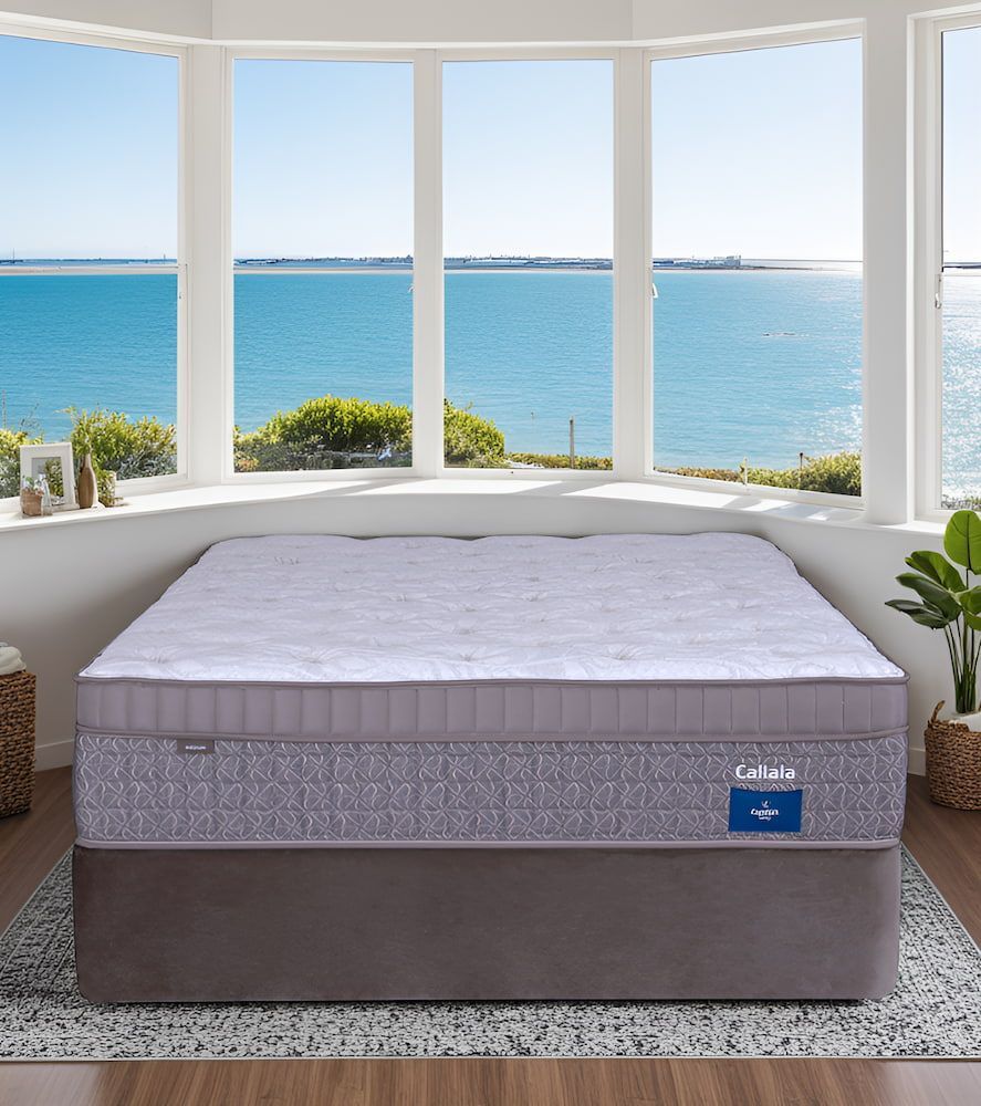 A Mattress Is Sitting In Front Of A Window Overlooking The Ocean — Coastal Mattress' Direct in Ulladulla, NSW
