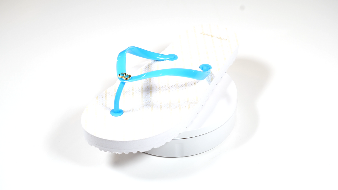 A pair of white flip flops with blue straps