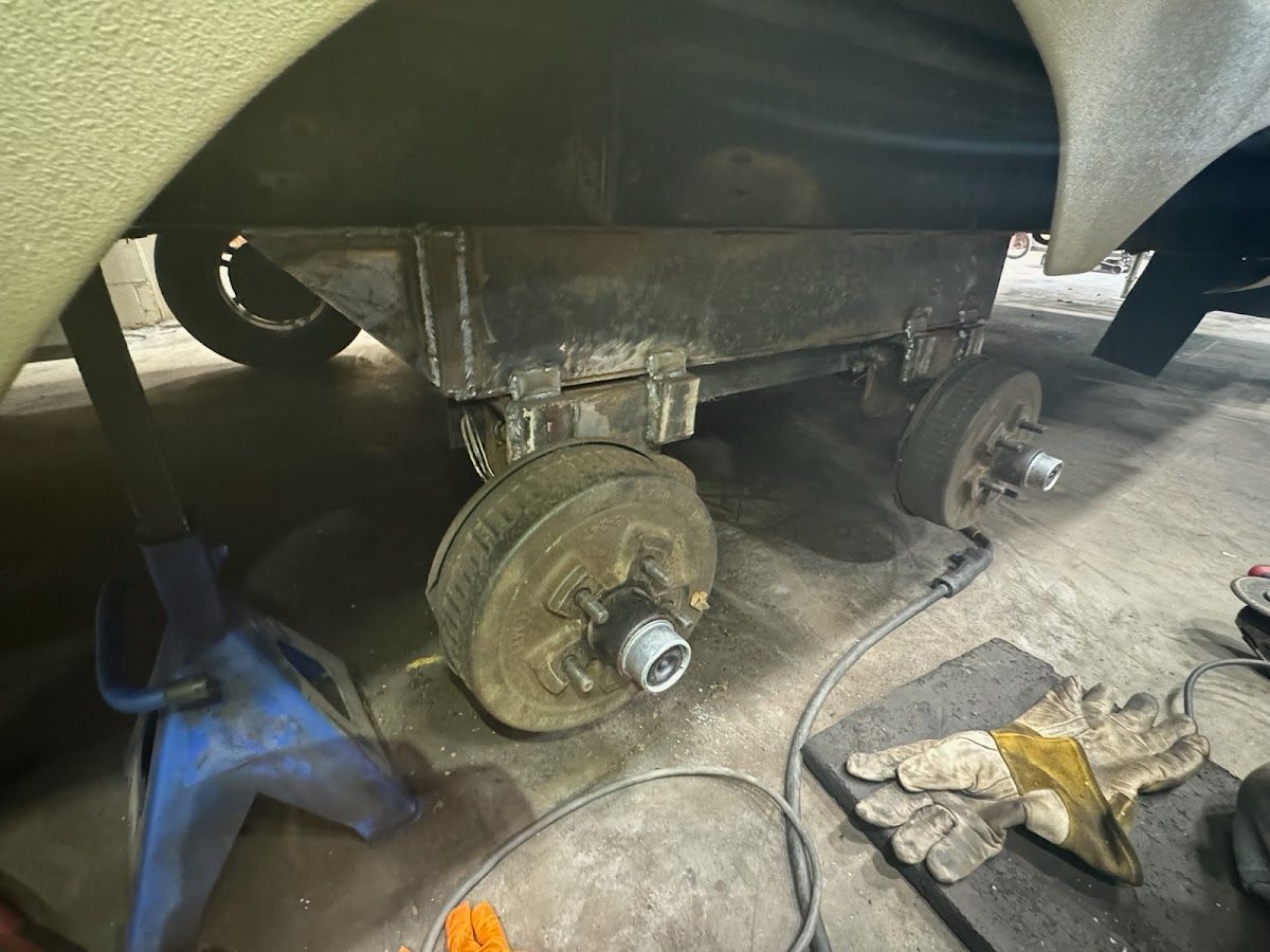 A car is being worked on in a garage.