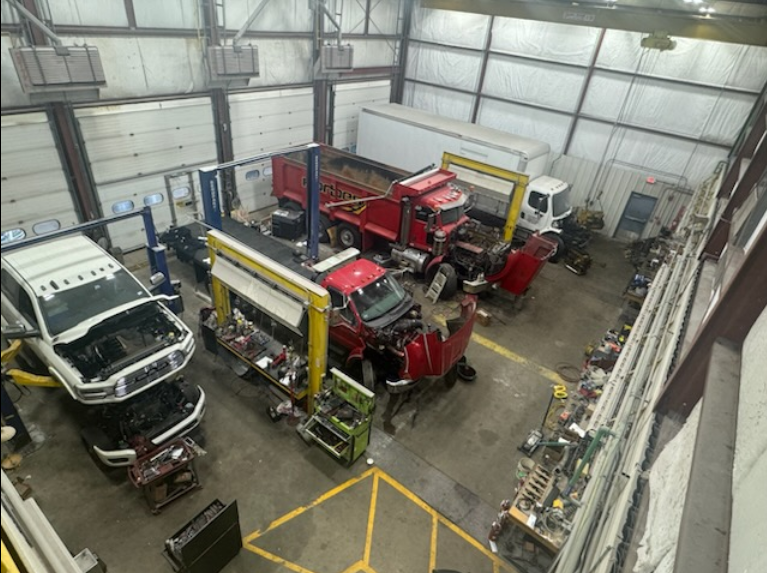 An aerial view of a truck repair shop with trucks being worked on
