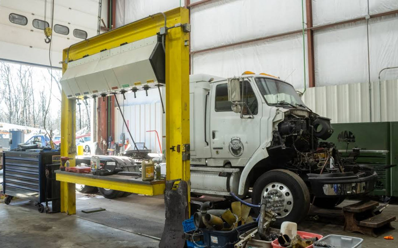 A truck is being worked on in a garage.