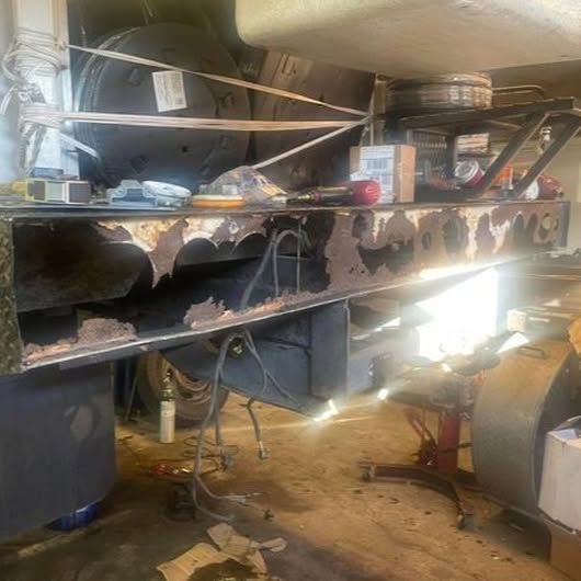 A garage with a lot of junk on the floor