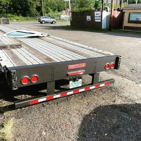 A tow truck is parked on the side of the road.