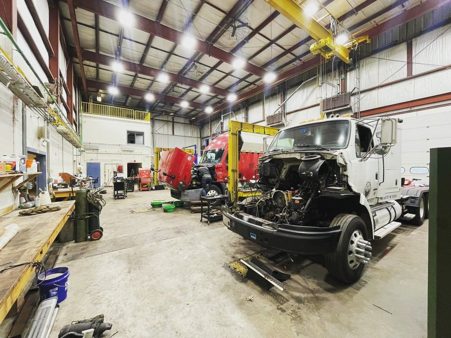 A truck is being worked on in a garage.