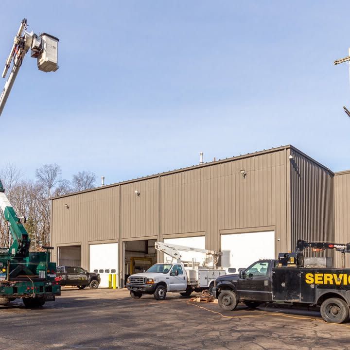 A service truck is parked in front of a building