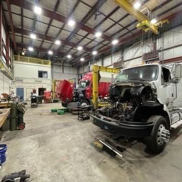 A truck is being worked on in a garage.