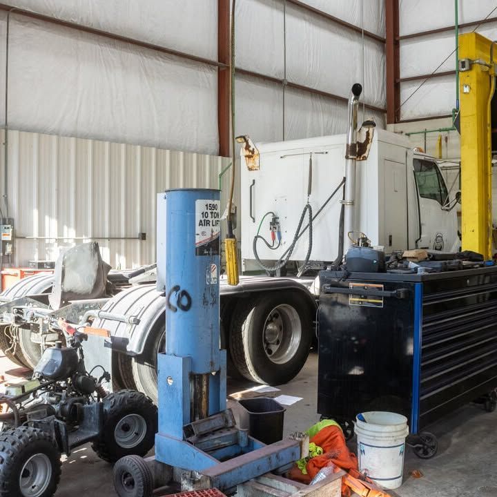 A truck is being worked on in a garage