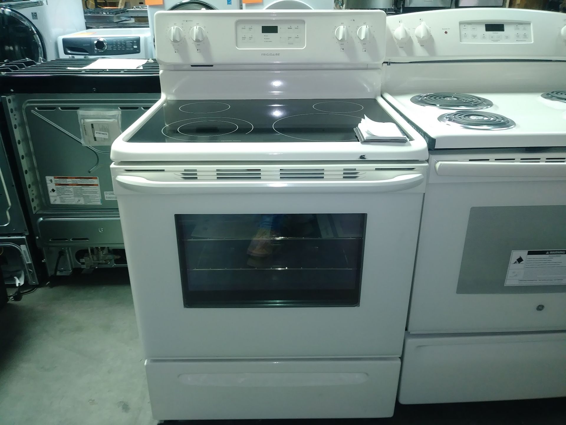 White electric range with a glass cooktop and oven.
