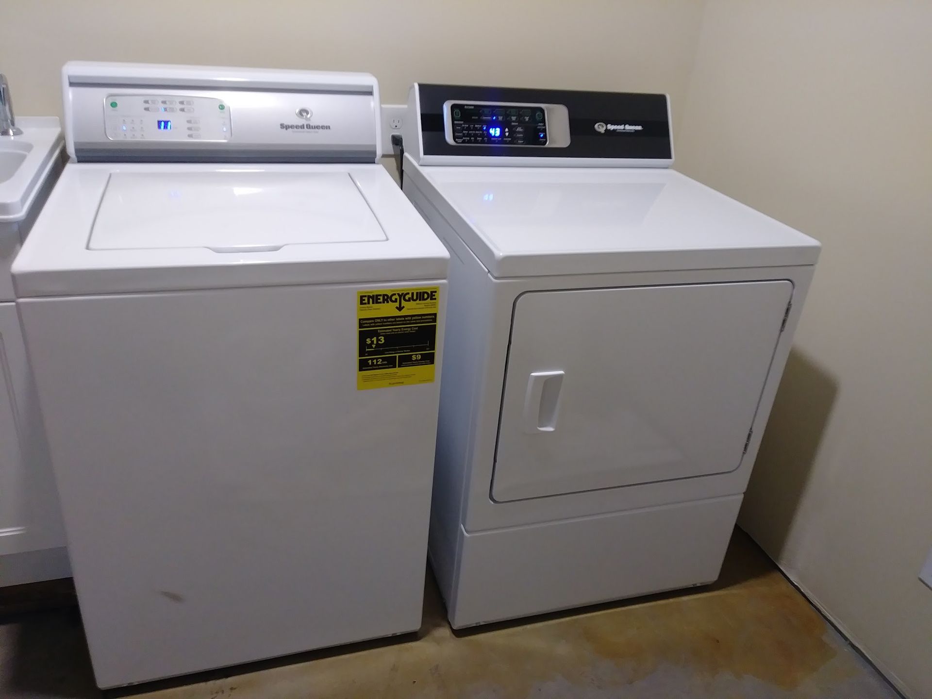 White washing machine and dryer set in a utility room.