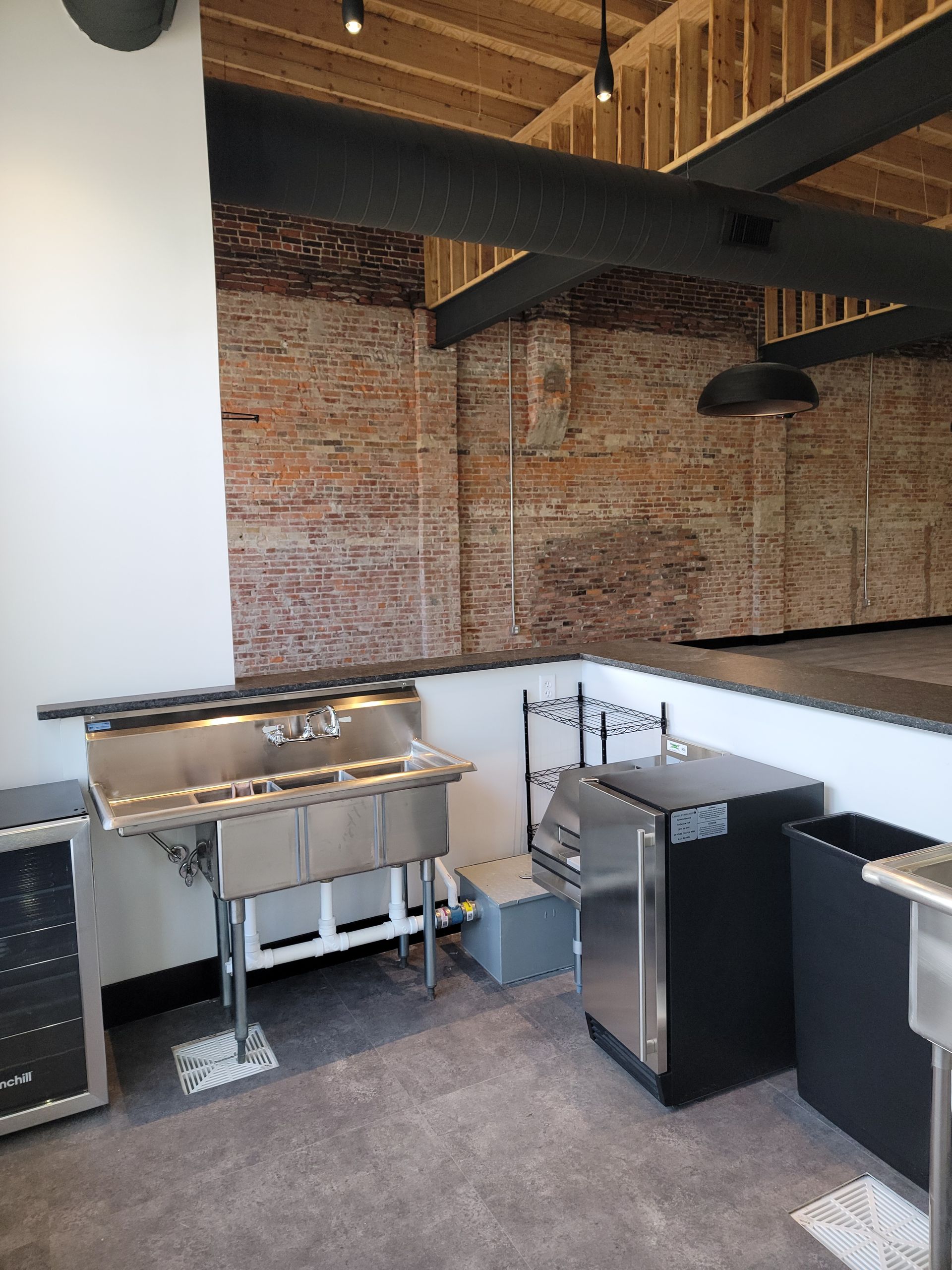 Bar with sink, small fridge and cooler + storage at next to the entrance