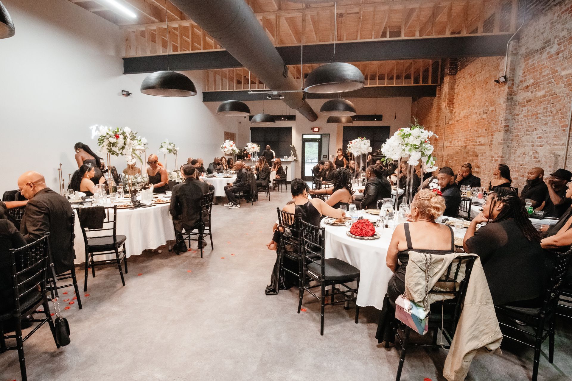 The event center filled with people enjoying the decor, family and friends.