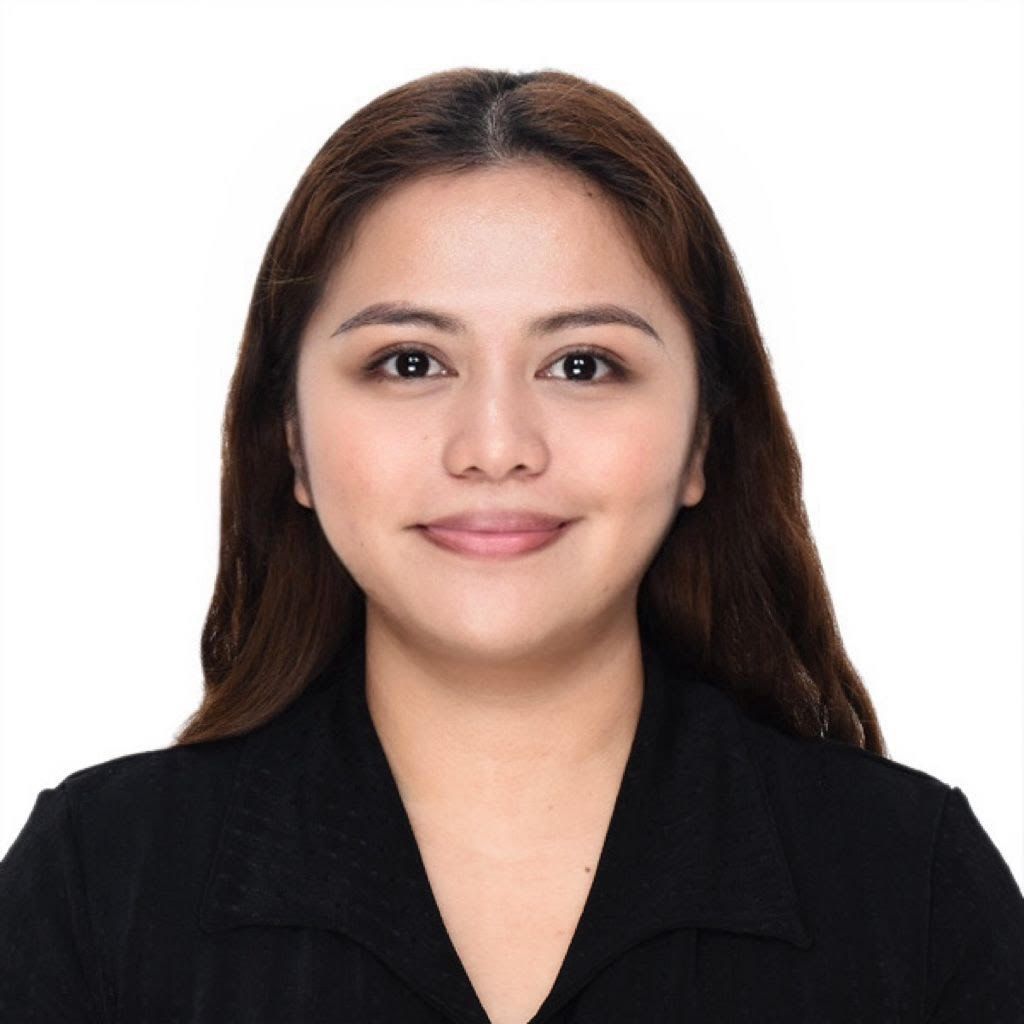 A man in a suit and vest is standing in front of a white background.
