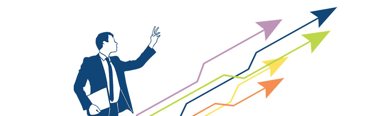 A man in a suit and tie is pointing at a growing graph.