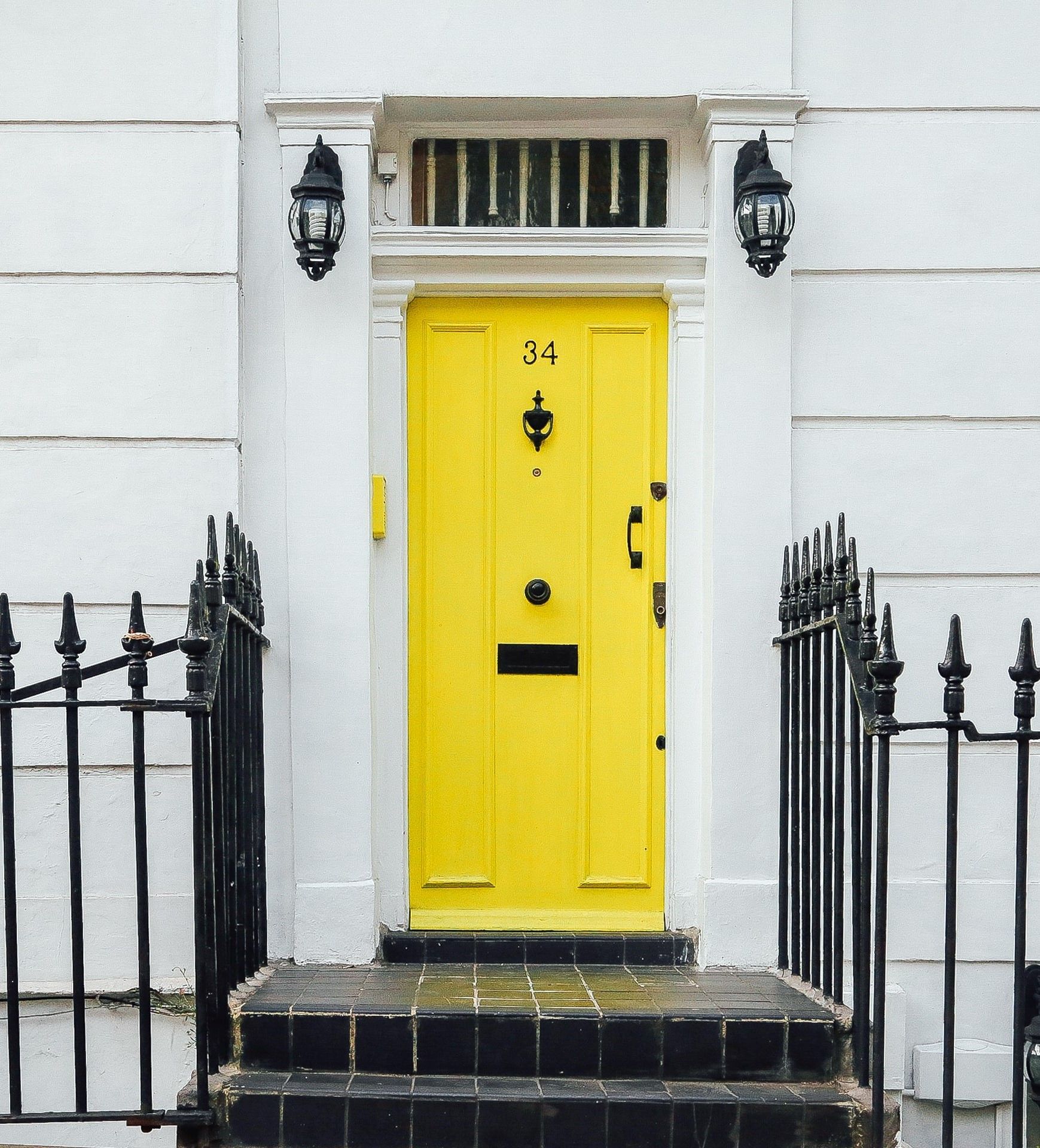Front of house with  bright yellow door