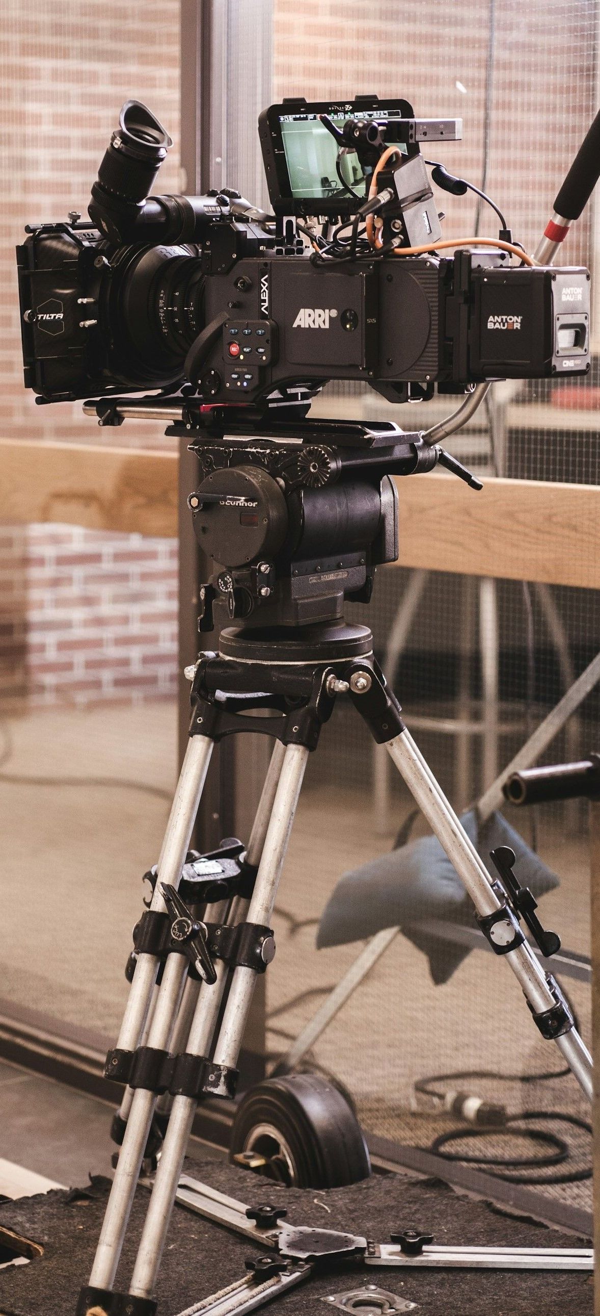 A camera is sitting on a tripod on a table.