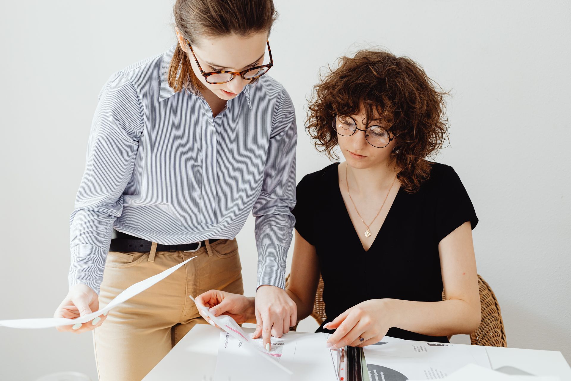 Two female employees looking over paperwork