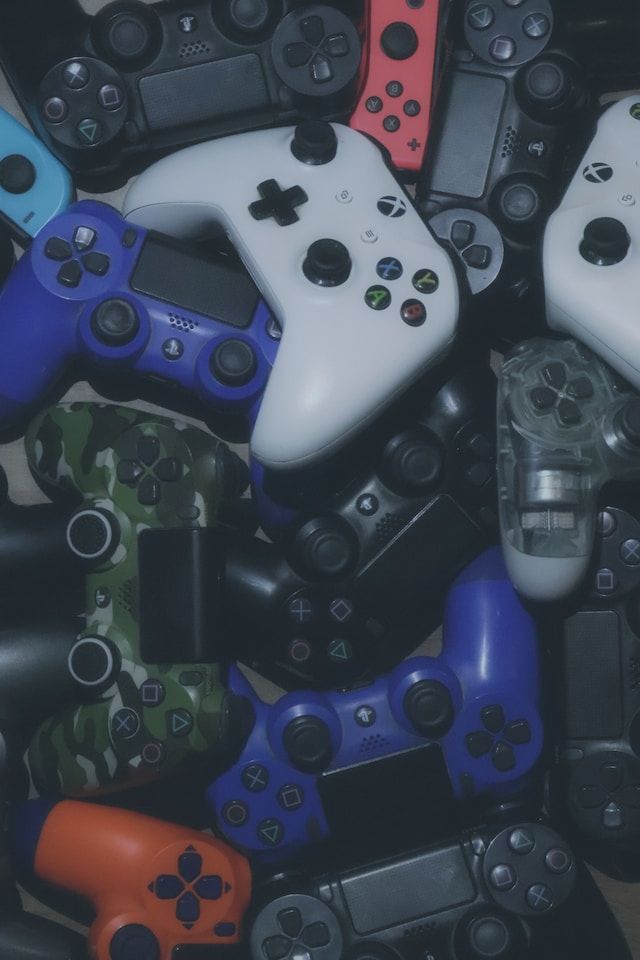 A bunch of video game controllers are stacked on top of each other