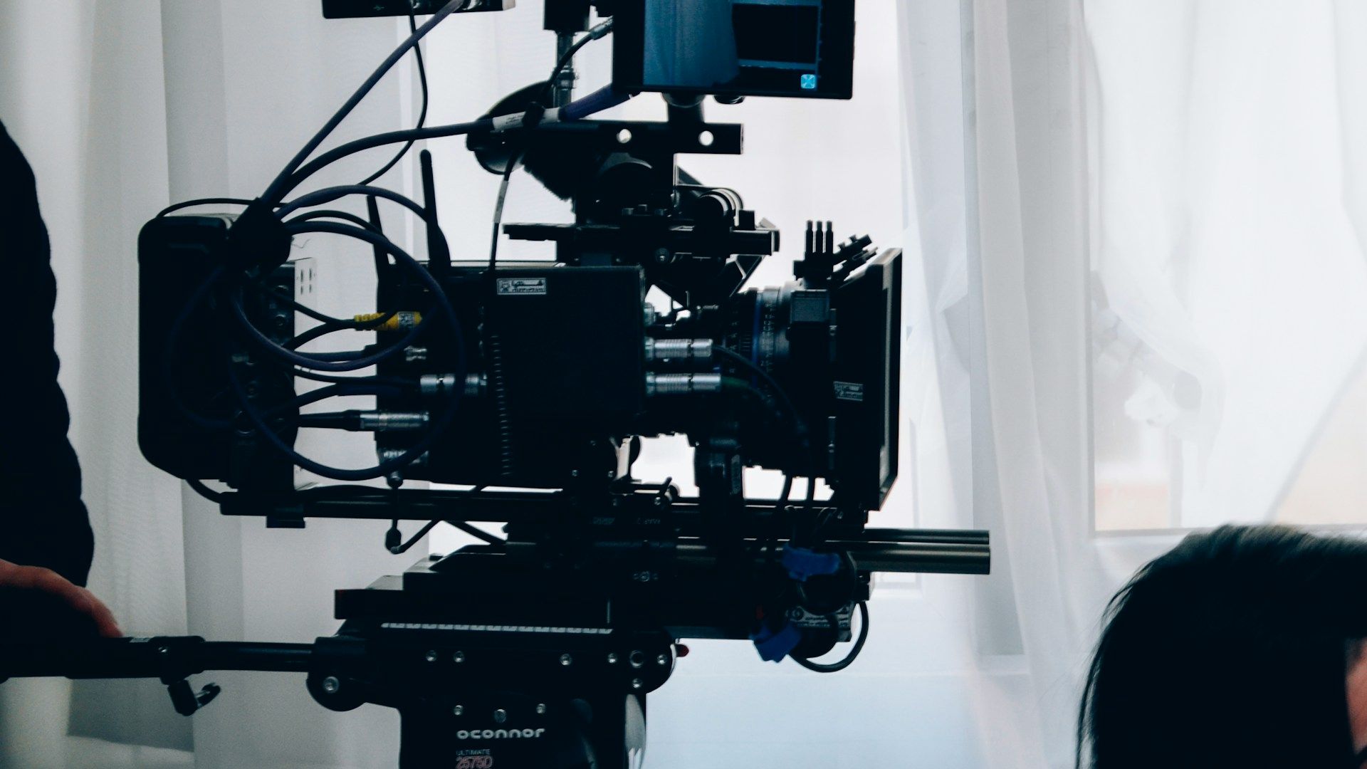 A man and a woman are sitting at a table with a laptop.
