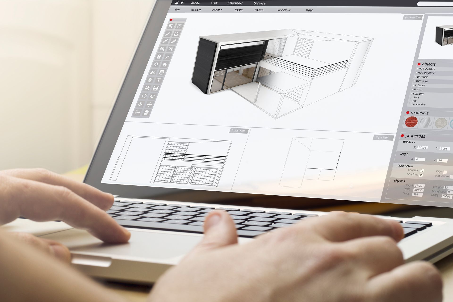 Une personne tape sur un ordinateur portable avec un modèle 3D d’une pièce sur l’écran.