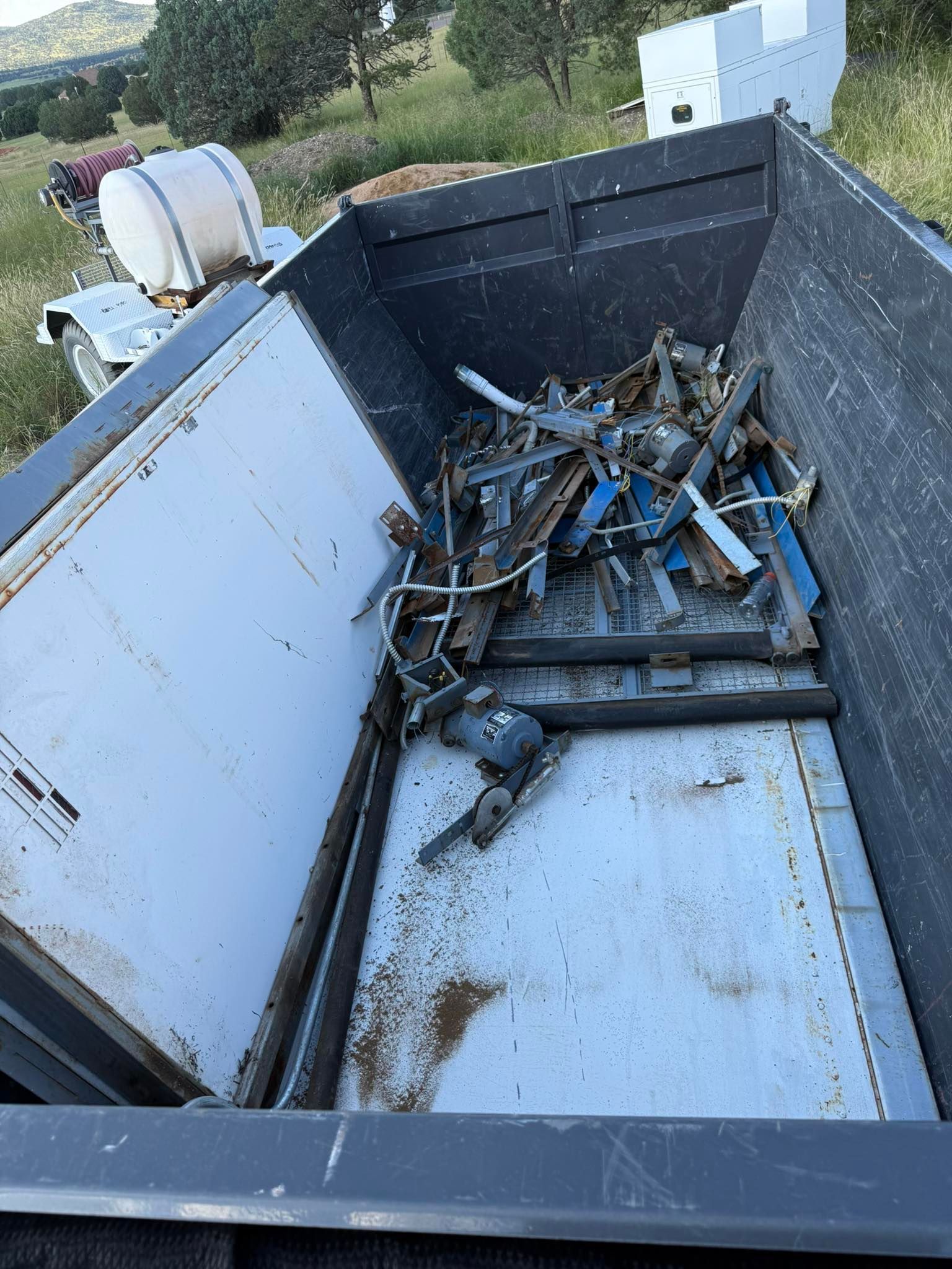 Metal scraps inside a large, open container, likely for recycling.