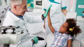 Happy Kid Giving Five to Dentist Happy Kid Giving Five to Dentist