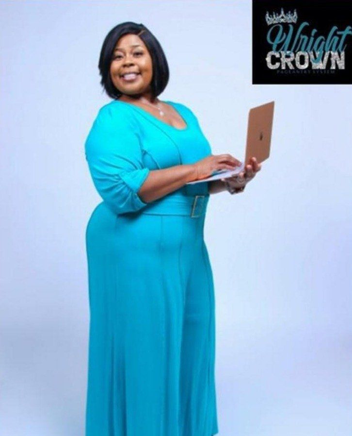 Woman Holding A Laptop While Standing