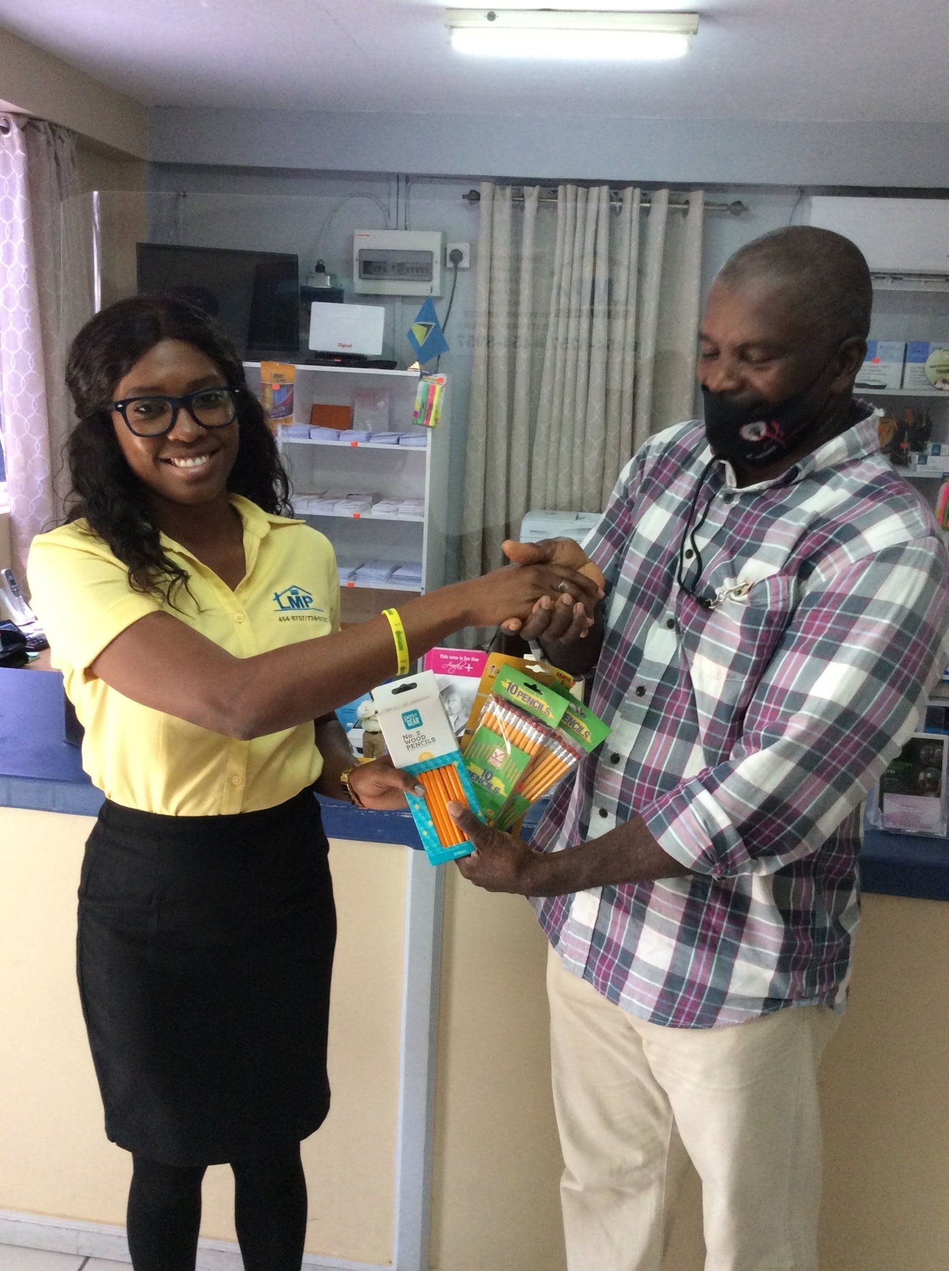 Coordinators Handing Over School Supplies