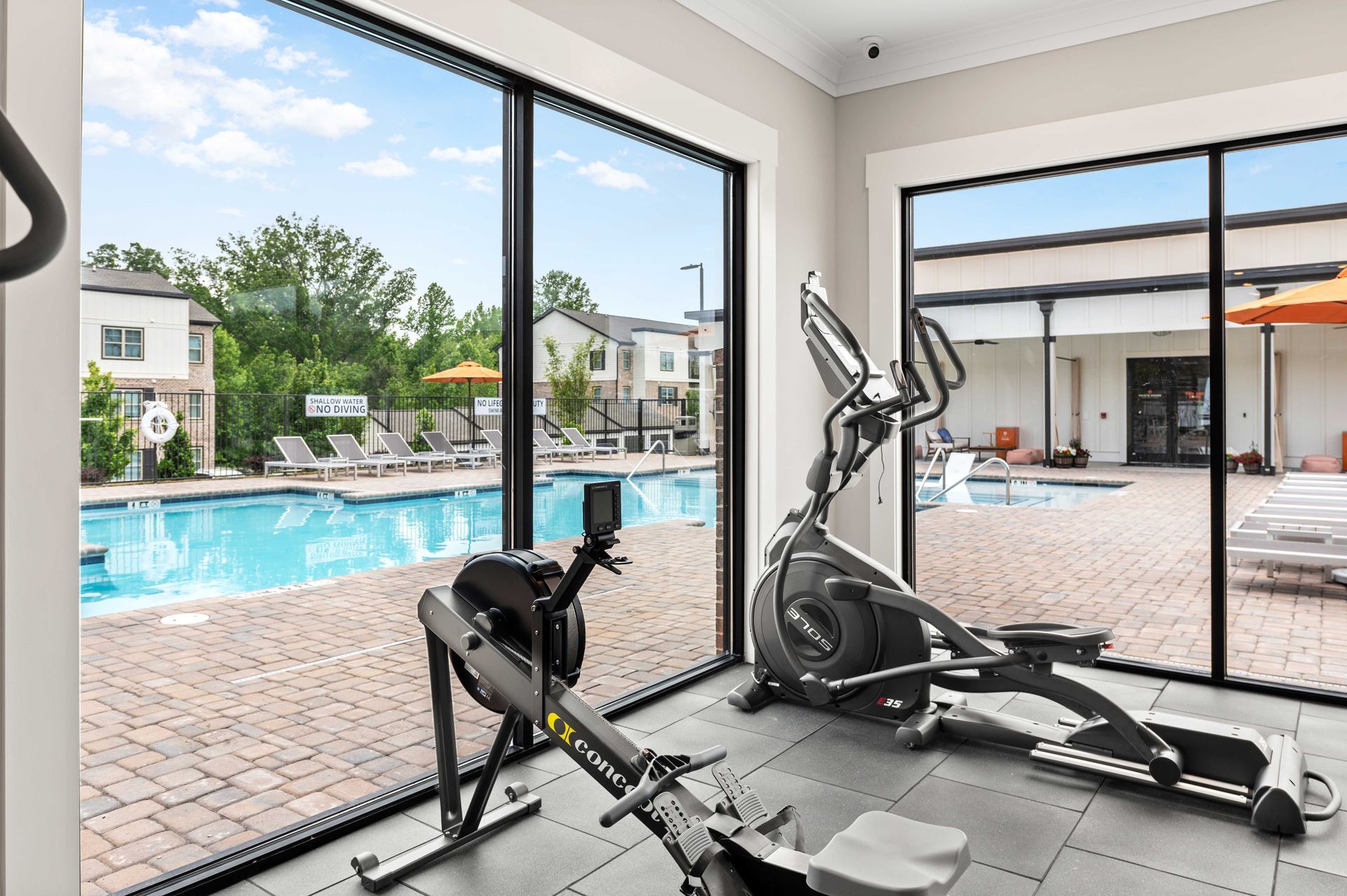 A fitness center with a rowing machine and an elliptical machine.