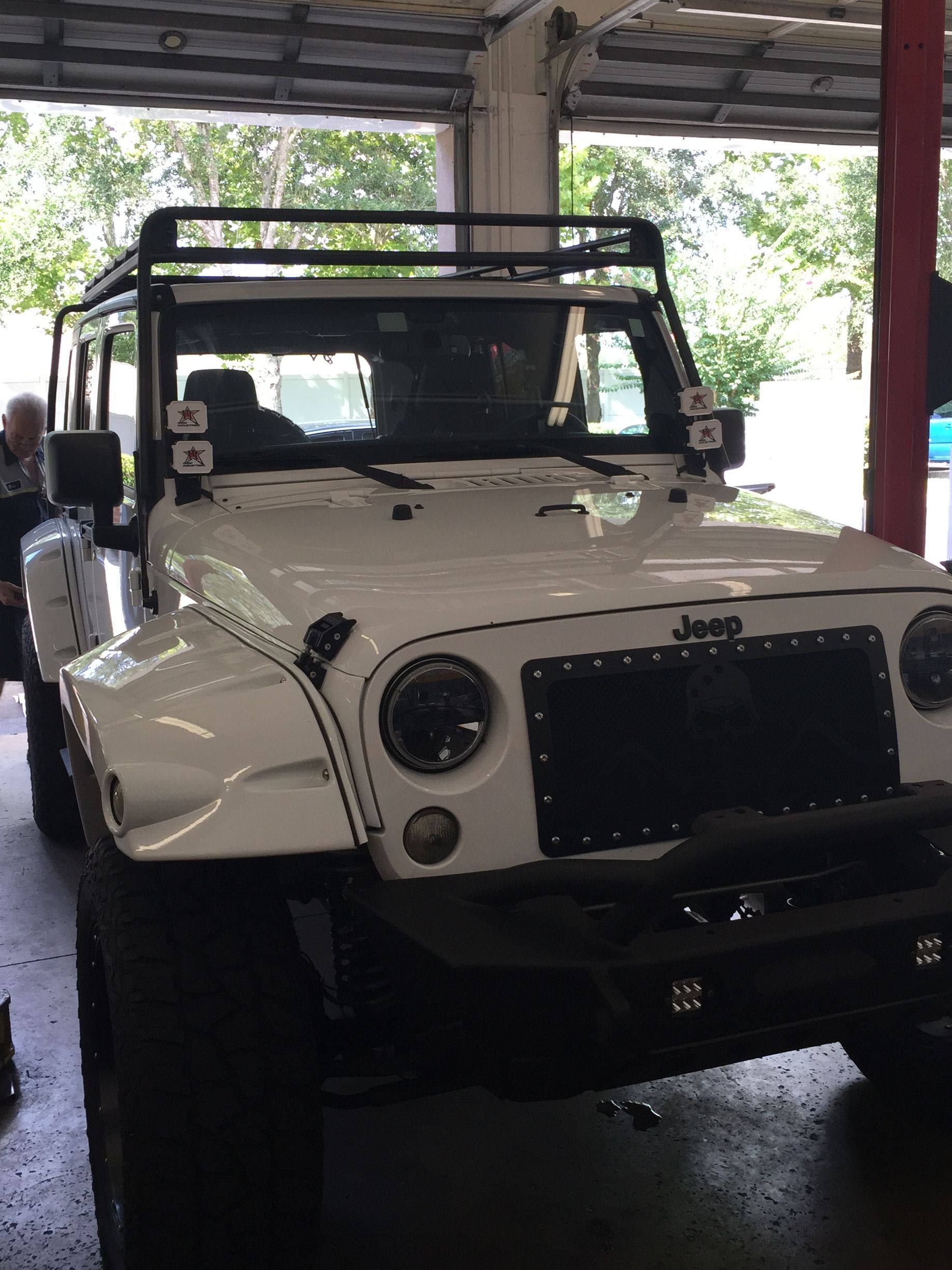 A White Jeep Parked for Repair at Mr. Best Wrench