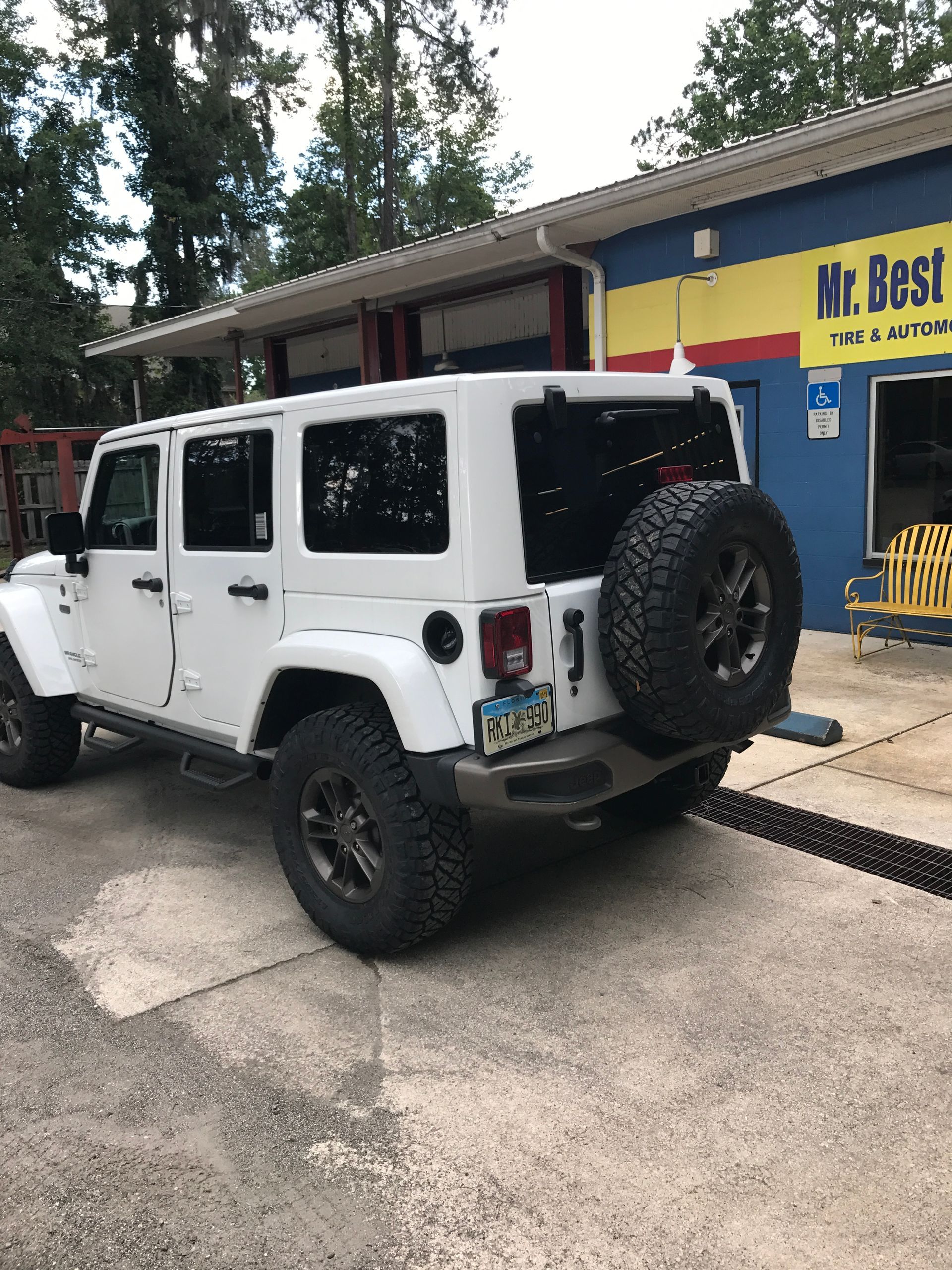 A White Jeep is Parked in Front of Our Service Shop Center - Mr. Best Wrench