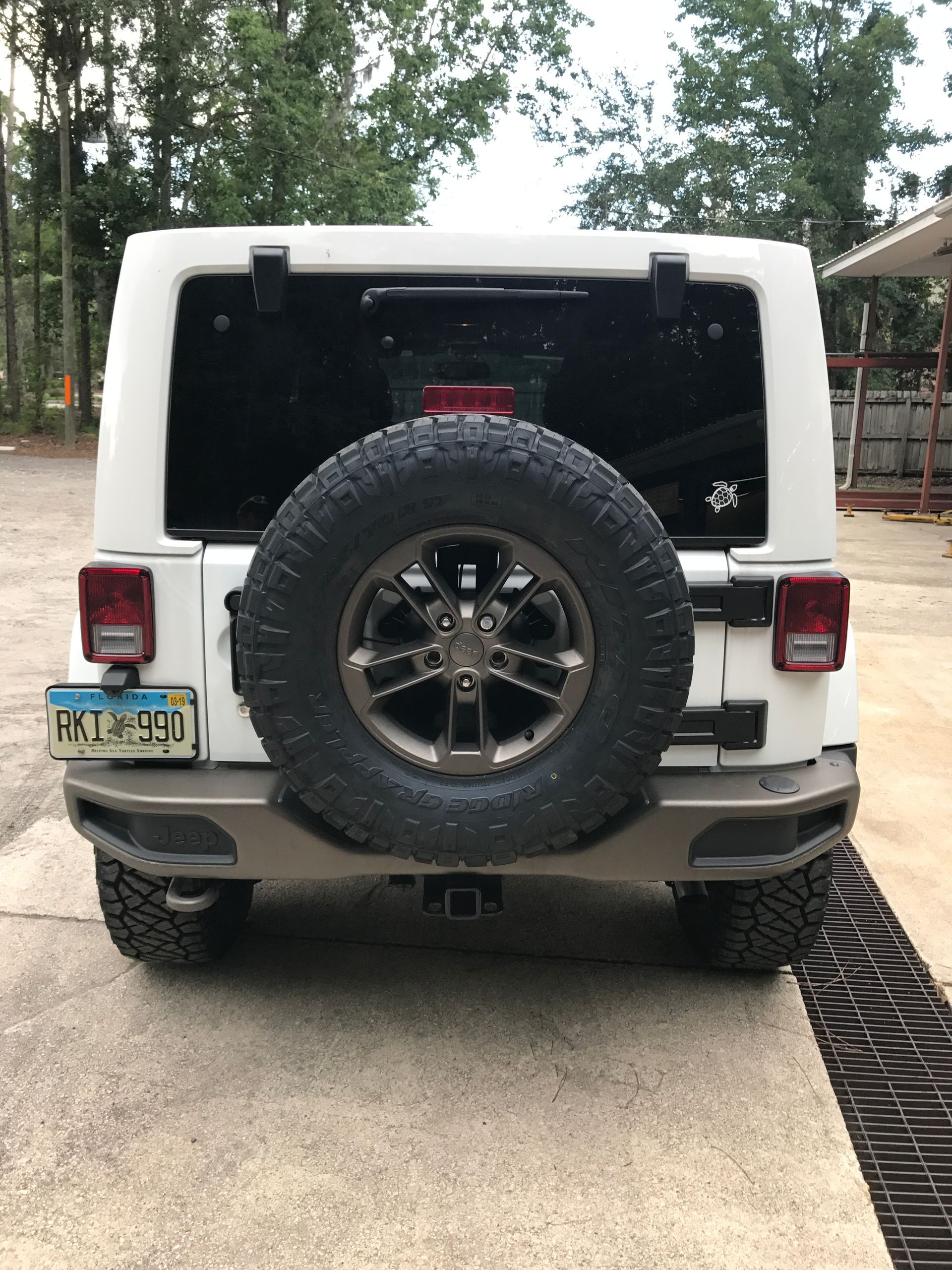 A White Jeep is Parked in Front of Our Garage in Jacksonville, FL - Mr. Best Wrench