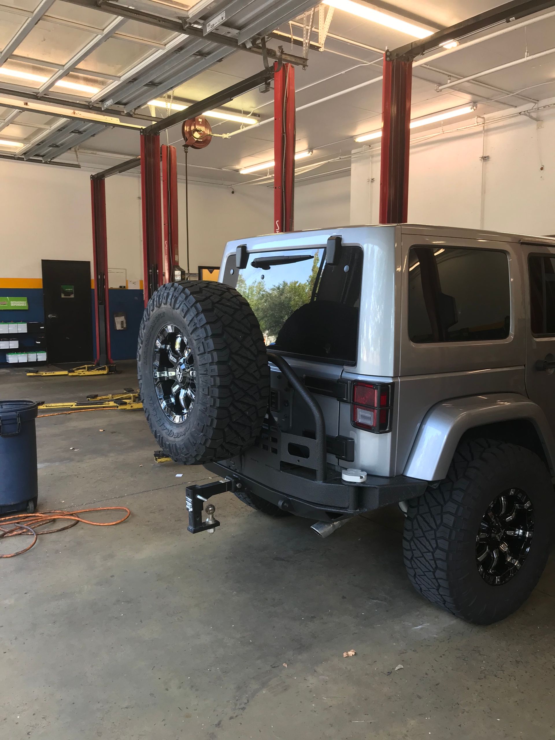 A Jeep With a Spare Tire Attached to the Back in Our Garage in Jacksonville, FL - Mr. Best Wrench