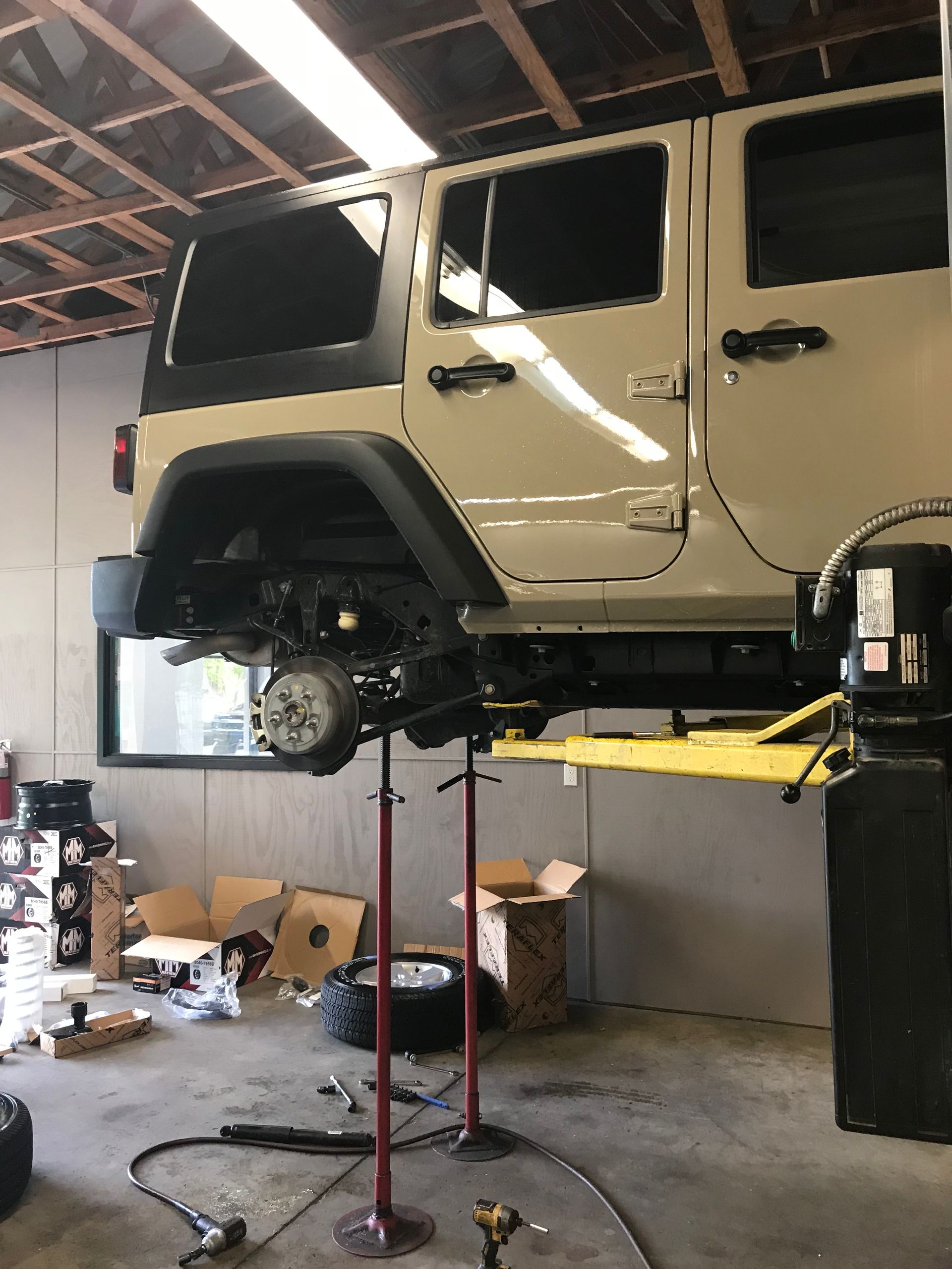 A Jeep is Sitting on a Lift at Mr. Best Wrench
