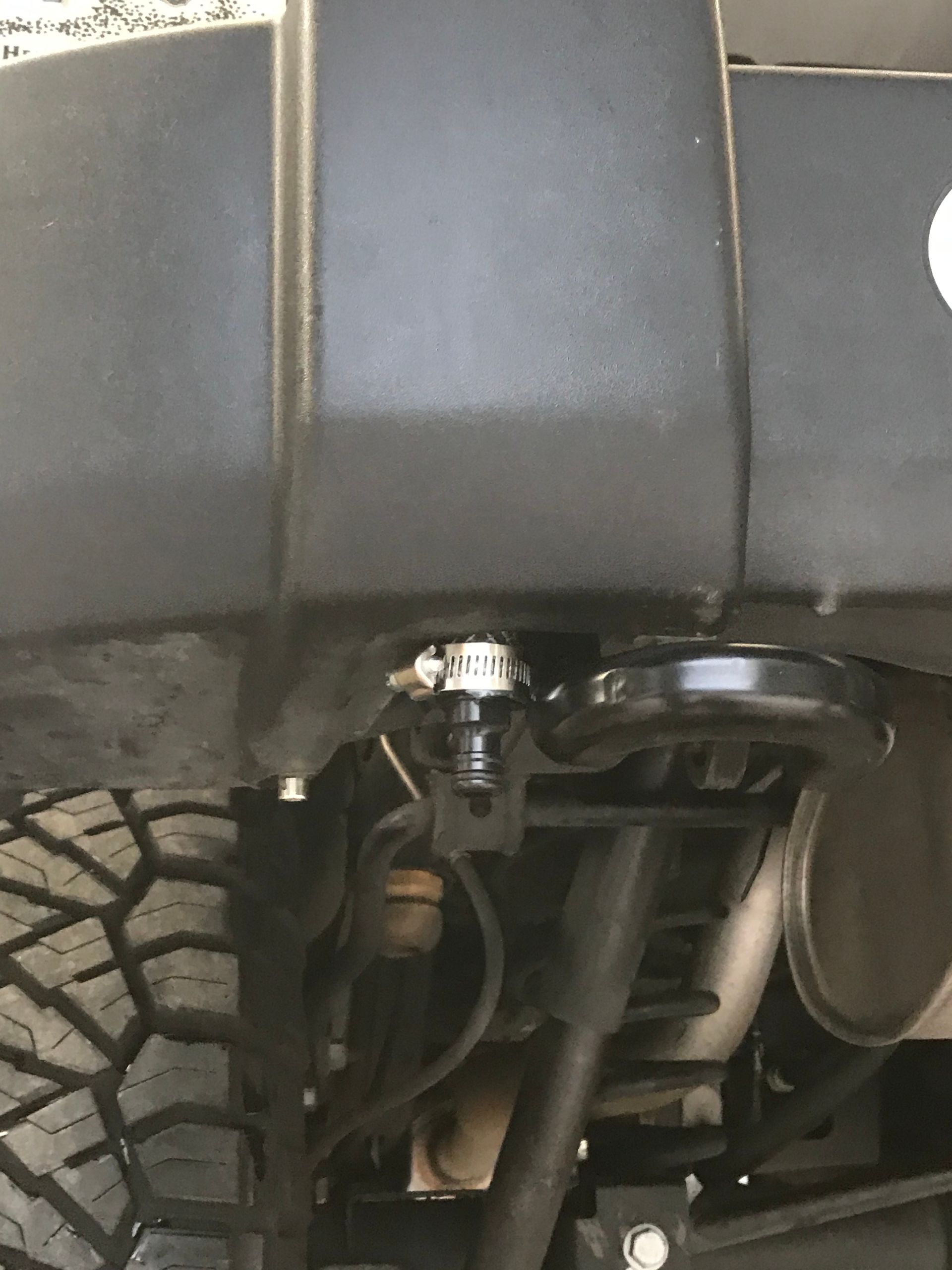 A Close-Up of the Underside of a Car With a Tire on it  - Mr. Best Wrench